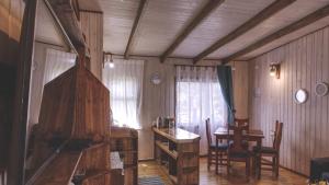 Habitación con escritorio, mesa, mesa y sillas. en Cabaña Los Coihues, en Puerto Montt