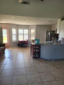 a kitchen with a counter and a table in it at Beautiful 3 bedroom home 4 minutes from the beach in Pensacola