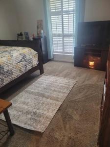a bedroom with a bed and a fire place at Beautiful 3 bedroom home 4 minutes from the beach in Pensacola