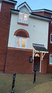 a brick house with a door and two parking meters at Southampton centre - 1 bed studio flat in Southampton