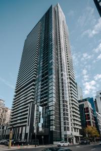 a large tall building with cars parked in front of it at Stylish Suite at 300 Front Street W in Toronto