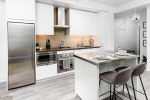 a kitchen with stainless steel appliances and a counter at Stylish Suite at 300 Front Street W in Toronto