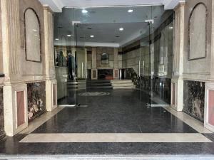 a lobby with a man in a suit in a building at Best view , New furniture Gameat Al Dewal Al Arbeya in Cairo