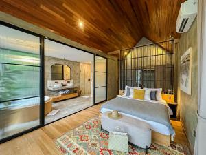 a bedroom with a large bed and a large window at Magical Jungle Resort in Ubud +88 photos