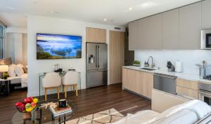 a kitchen and a living room with a table at Stylish Condo By The Beach in Los Angeles