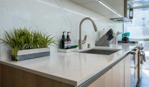 a kitchen counter with a sink and some plants at Stylish Condo By The Beach in Los Angeles