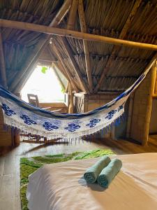 two towels laying on a bed in a hammock at Guajira Beach in Ríohacha
