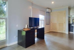 ein Wohnzimmer mit einem Schreibtisch und einem TV in der Unterkunft RedDoorz @ Padi Beach Resort Oton Iloilo in Oton
