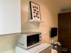 a microwave sitting on a counter in a room at Penthouse Perfection in Manila