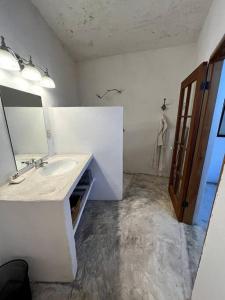 a bathroom with a sink and a mirror at Casa de Flaco in Álamos