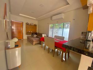 uma cozinha e sala de estar com mesa e cadeiras em Casa no Condomínio Jardim Europa em Macapá