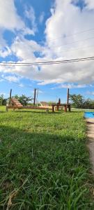 a wooden fence in a field with green grass at Quinta Loma Hermosa in Aldea Brasilera