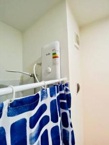 a blue and white towel hanging on a rack at Departamento amoblado in Piura