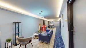 a waiting room with a blue couch and a chair at Blue Lagoon At Bandar Sunway in Petaling Jaya