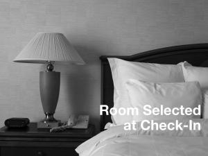 a bedroom with a bed with a lamp and a phone at Holiday Inn Express & Suites Poteau, an IHG Hotel in Poteau