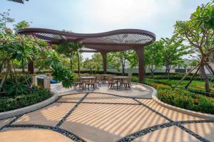a patio with tables and chairs in a park at Kim Villa Swan Bay - Zone 8 in Phước Lý
