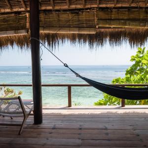 a hammock in a resort with a view of the ocean at Rock'n Reef in Uluwatu