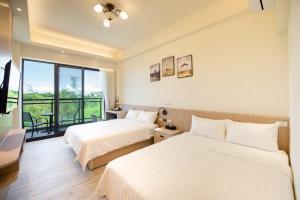 Vuode tai vuoteita majoituspaikassa 小琉球遇見海旅宿