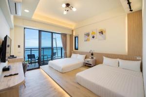 Vuode tai vuoteita majoituspaikassa 小琉球遇見海旅宿
