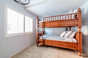 a bedroom with two bunk beds and a window at Bayfront Paradise- Bay Views & Boardwalk Patio in San Diego