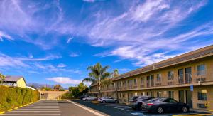 a parking lot in front of a building with cars parked at New Star Inn El Monte, CA - Los Angeles in El Monte