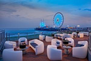 a view of a pier with chairs and a ferris wheel at Nice Unit at The Hard Rock Cafe Casino Atlantic City in Atlantic City