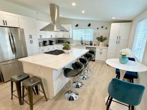 a kitchen with a large white island with a counter top at Disneyland Retreat-Pool Spa Game in Anaheim