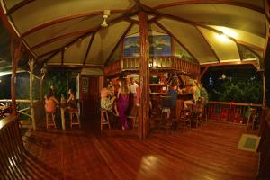 a group of people sitting at a bar in a tent at Poor Man's Paradise Lodge in Drake