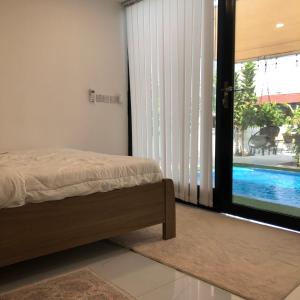 a bedroom with a bed next to a sliding glass door at استراحة الدرر خاصه لنساء ولازواج 