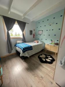 a bedroom with a bed and a window at Casa en Lago Ranco in Ignao