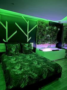 a green bedroom with a bed with plants on it at Suite Dream by Need'Amour in Pontault-Combault