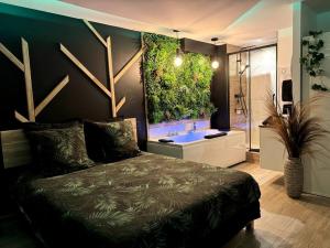 a bedroom with a bed with a large aquarium on the wall at Suite Dream by Need'Amour in Pontault-Combault