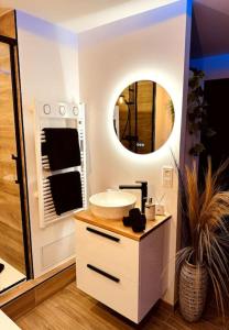 a bathroom with a sink and a mirror at Suite Dream by Need'Amour in Pontault-Combault