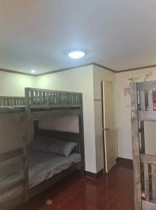 a room with two bunk beds in a room at Dantes place in Lumban