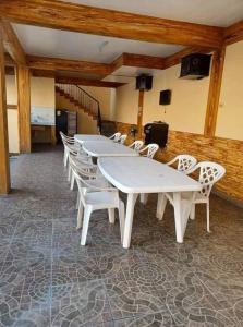 une rangée de tables et de chaises blanches dans une pièce dans l'établissement Dantes place, à Lumban