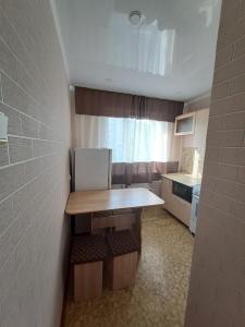 a small kitchen with a table in a room at 408 квартал in Semey