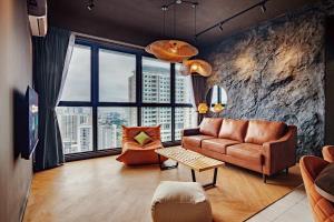 a living room with a couch and a large window at Urban Suites, Autograph Collection by Stellar ALV in Jelutong