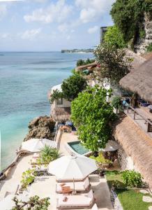 an aerial view of a resort with a swimming pool and the ocean at Rock'n Reef in Uluwatu