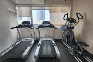 a gym with three treadmills in a van at ONE Residence in Pathum Thani