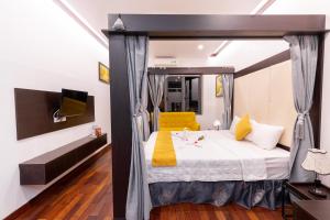 ein Schlafzimmer mit einem Himmelbett und einem gelben Stuhl in der Unterkunft Hanoi Cozy Legend Hotel in Hanoi