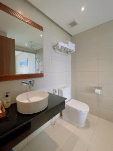 a bathroom with a sink and a toilet at Queen Apec Mandala Phú Yên Condotel in Tuy Hoa