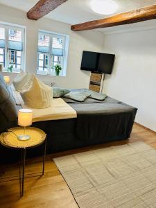 a large bed in a living room with a couch at Studio Reichenstrasse in Quedlinburg