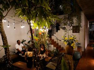 a group of people sitting in a room with plants at Notre Maison 8 Saigon close Landmark 81 building in Ho Chi Minh City