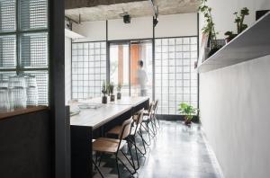 a dining room with a long table and chairs at 軟寓 nńg inn in Tainan