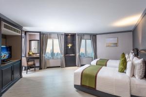 a hotel room with a bed and a television at Baiyoke Sky Hotel in Bangkok
