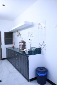 a kitchen with a black counter top in a room at HOMESTAY ( EAGLE NEST ) in Bhuj