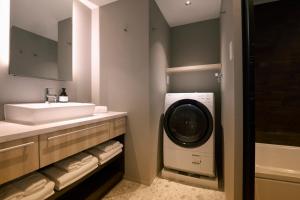 a bathroom with a sink and a washing machine in it at FAV LUX Nagasaki in Nagasaki +47 photos