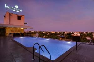 a swimming pool on the roof of a hotel at Lemon Tree Hotel, Hubli in Hubli