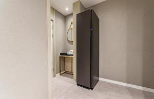 a black refrigerator in a room with a table at Hotel Bon in Tongyeong