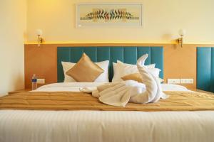 Postel nebo postele na pokoji v ubytování Hotel Turmeric